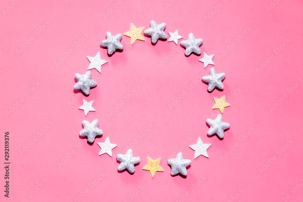 Christmas stars forming a circle with a pink background