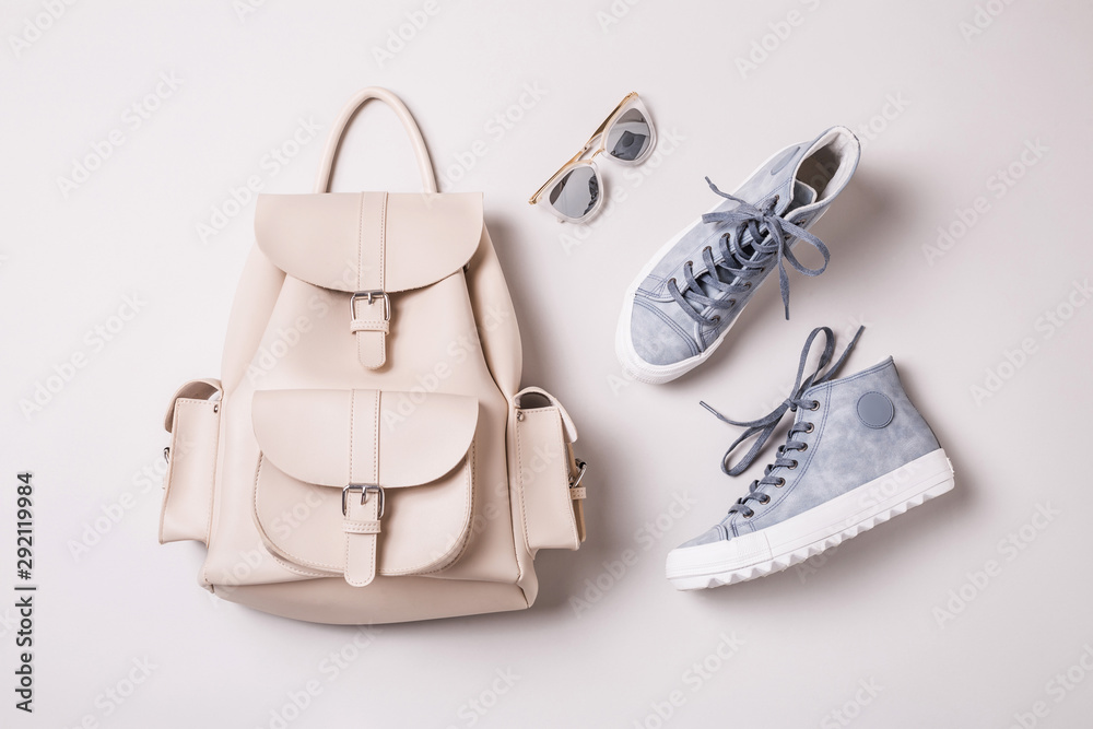 White backpack and pastel blue sneakers - fashion accessories - obrazy, fototapety, plakaty 