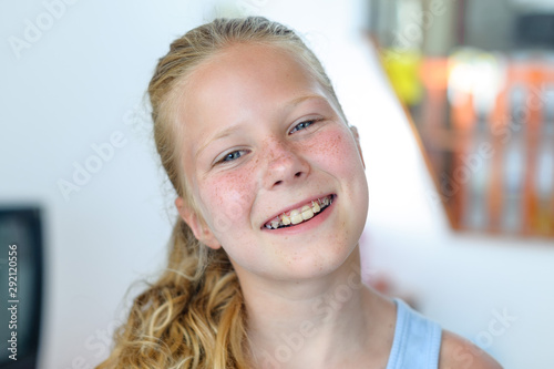 A teenage girl with a removable orthodontic appliance. Smiling with a bracket on her teeth. The concept of pediatric dentistry, bite correction. Portrait