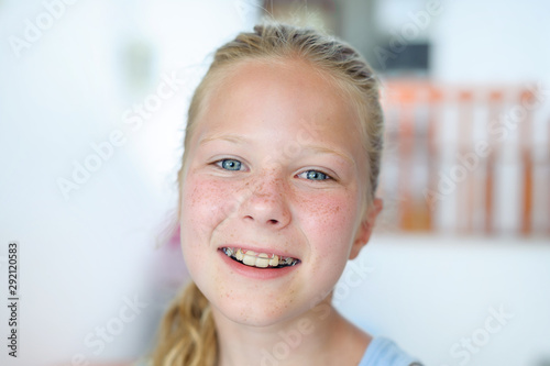 A teenage girl with a removable orthodontic appliance. Smiling with a bracket on her teeth. The concept of pediatric dentistry, bite correction. Portrait