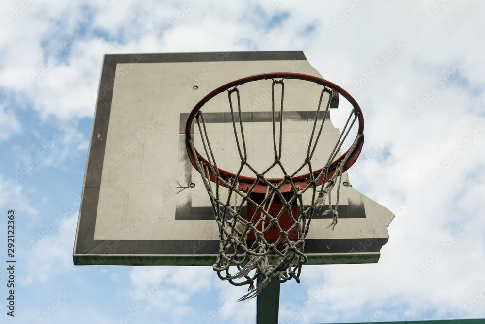 .broken basketball Hoop against the blue sky .broken basketball Hoop against the blue sky
