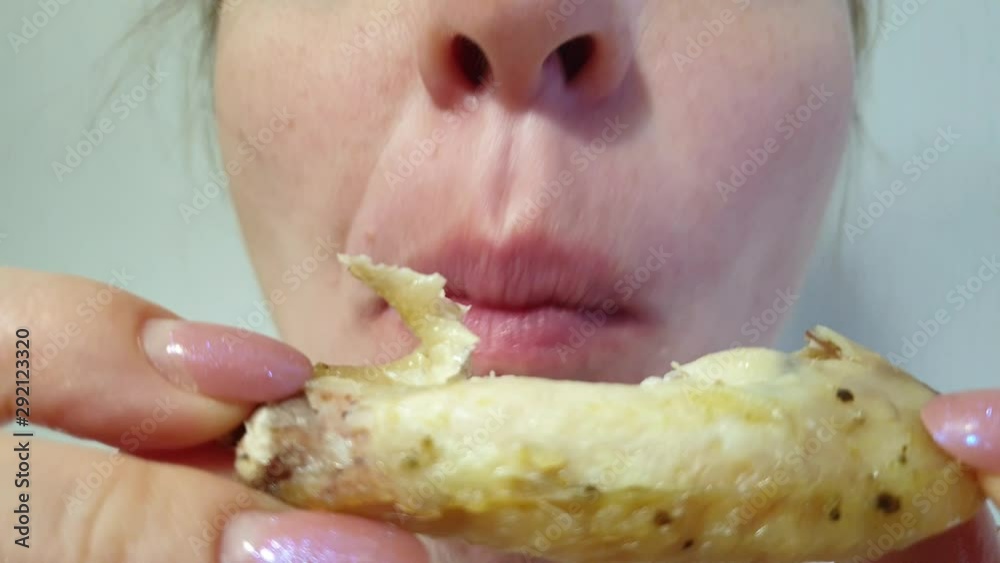 woman eats fried chicken, fatty and high-calorie food woman eats fried chicken, fatty and high-calorie food