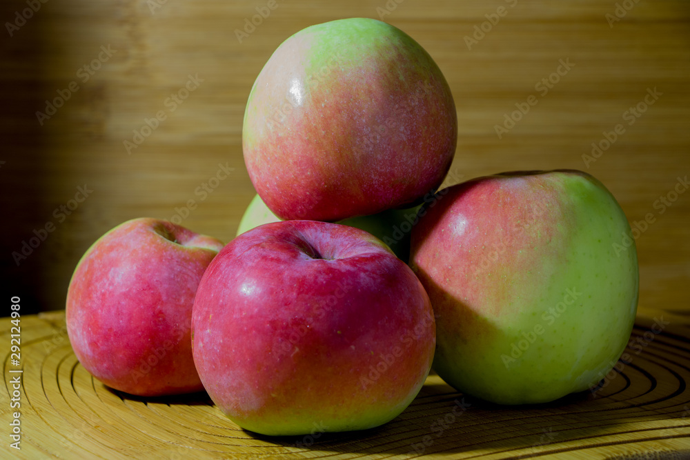 Image of apples on a beige, wooden background. Image of apples on a beige, wooden background.
