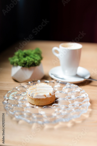 Cream tart with coffee. Dessert in cafe, selective focuse