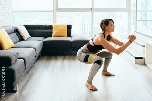 Adult Woman Training Legs Doing Side Squat at Home