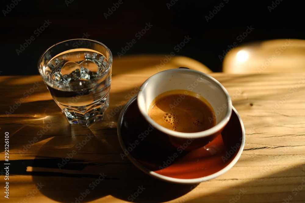 black coffee in a cup and a glass with water black coffee in a cup and a glass with water