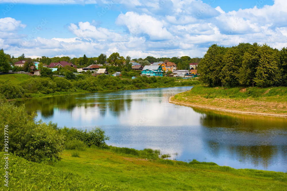 View on river and district with old wooden houses in Vologda. Russia