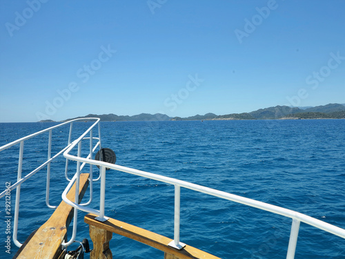 Blue sea and green island, view from the deck of yacht © alexrow