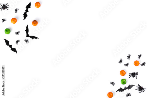 Halloween decorations on white background. Halloween concept made with pumpkins, bats, spiders and acorns. Flat lay, top view, copy space