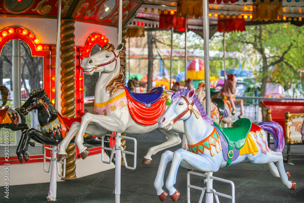 Fototapeta premium Merry-go-round with horses. Carousel with horses. Amusement Park in the city