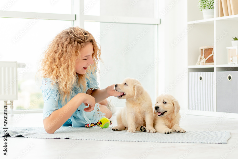 Girl relaxing with retriever puppies Girl relaxing with retriever puppies