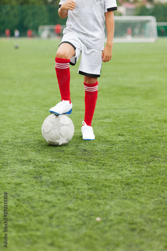 Cute child dreams of becoming a soccer player. Boy plays football Cute child dreams of becoming a soccer player. Boy plays football