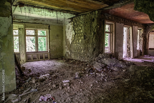 Interior of an old abandoned residental house full of crap with creepy look. photo