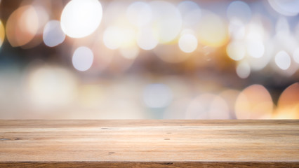 Wood table top on bokeh abstract background and used for montage or display products.