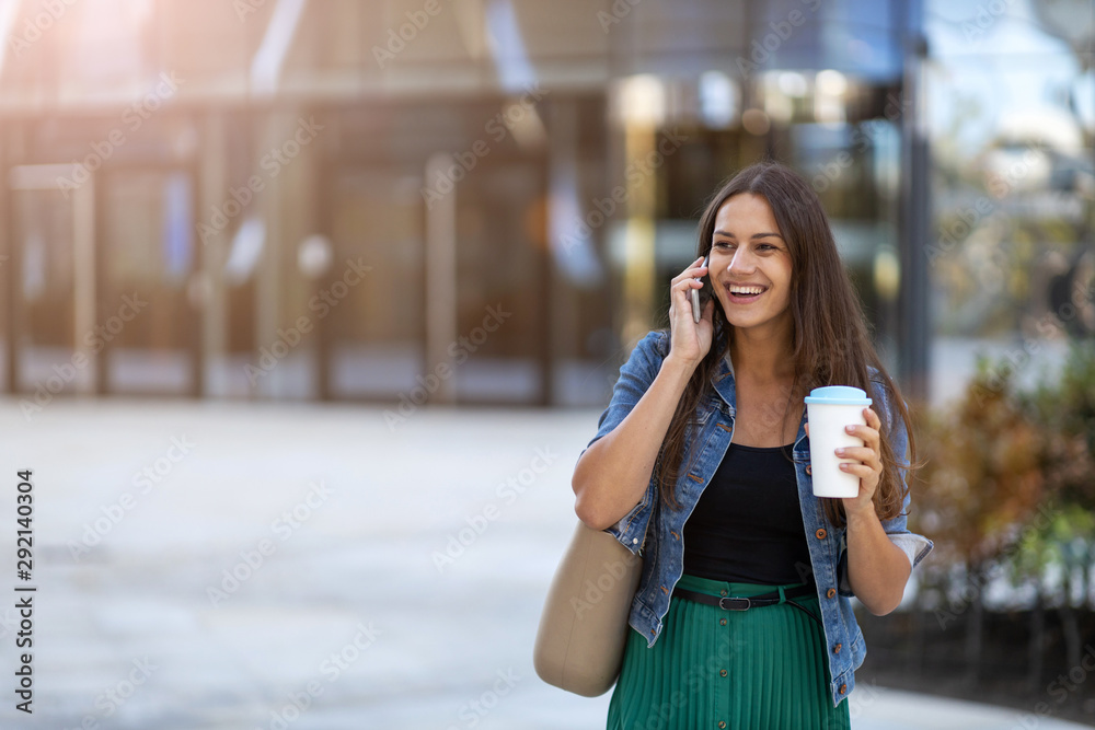 Young woman with smartphone and coffee in the city Young woman with smartphone and coffee in the city