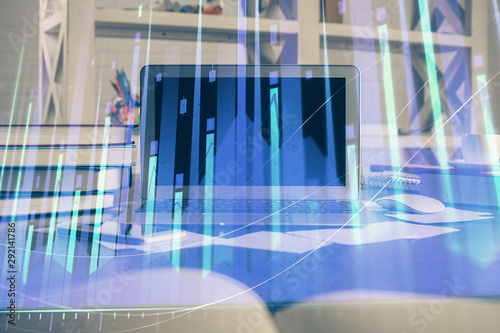 Financial chart drawing and table with computer on background. Double exposure. Concept of international markets.