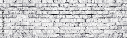 Whitewashed brick wall panoramic texture. White old brickwork masonry long panorama. Widescreen light grey background