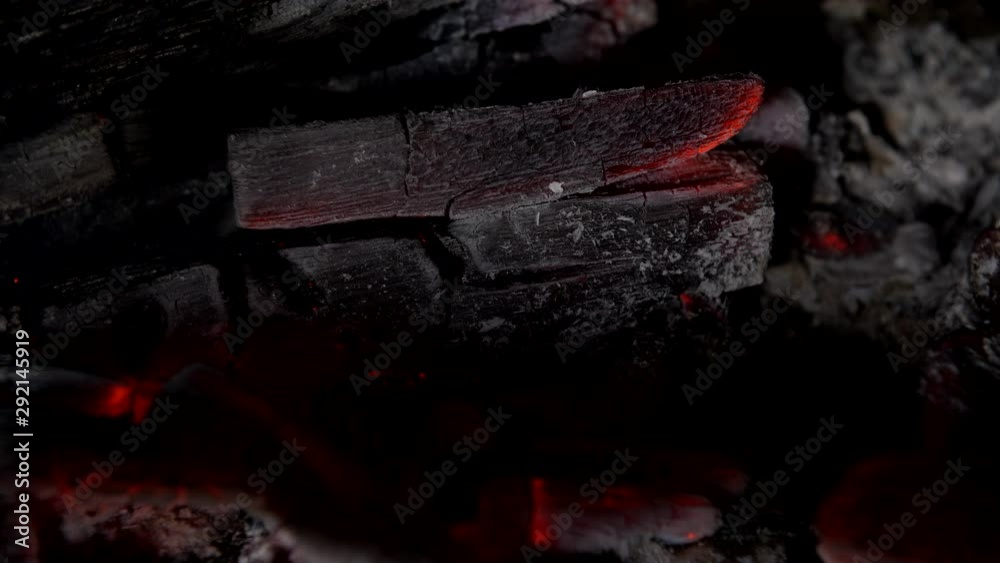 4K blowing on Log fire embers glowing red hot with flames, coals and ...