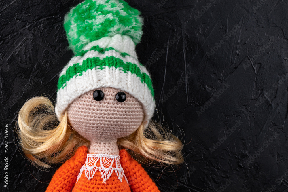 Fototapeta premium Knitted toy doll. Amigurumi toy. Crochet stuffed animals.