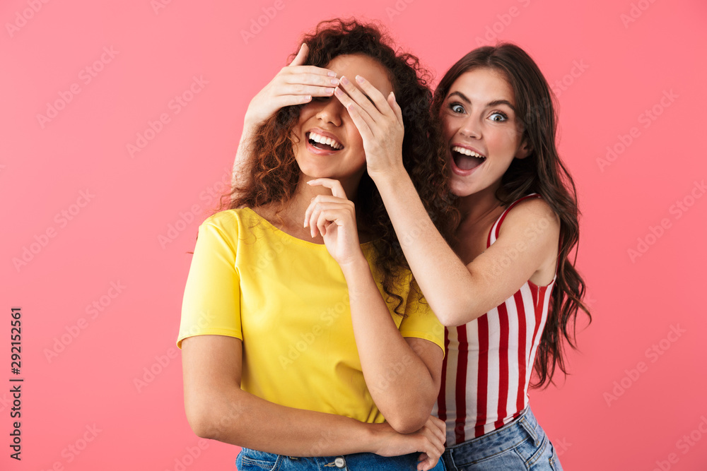 Image of happy multinational girls smiling and having fun with covering eyes Image of happy multinational girls smiling and having fun with covering eyes