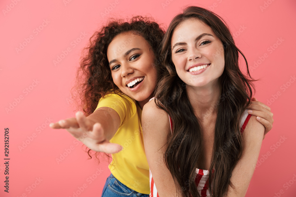 Image of attractive multinational girls smiling together at camera Image of attractive multinational girls smiling together at camera