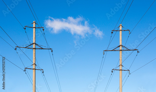 Canvas Print Two symmetrically located concrete power line poles