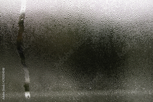 Fototapeta Condensation droplets on a window, abstract background
