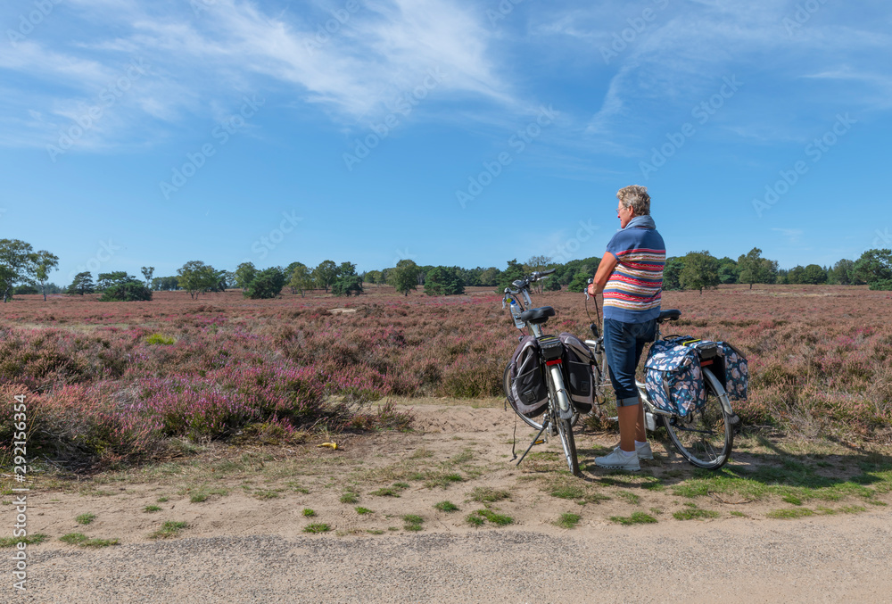woman with e bike on the dutch heather fields