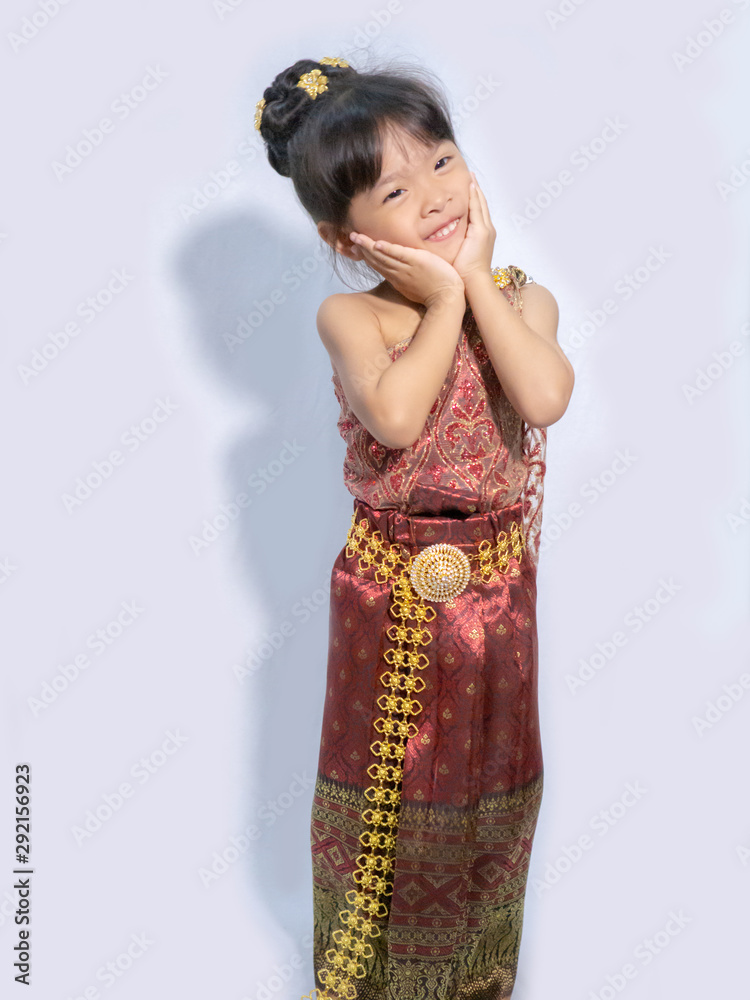 Thai little girl in traditional Thai costume in white background Thai little girl in traditional Thai costume in white background