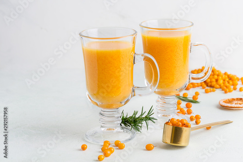 Bright sea buckthorn drinks in glasses on white background