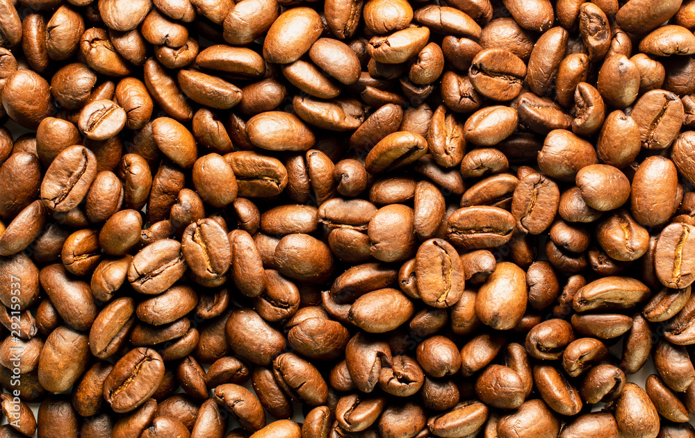 Naklejka premium Coffee beans background image. Top view of roasted coffee beans, macro shot.
