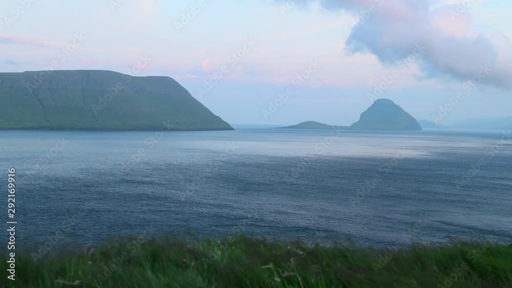Foggy morning view of a Hestur Island from Velbastadur village on Streymoy island, Faroe islands, Denmark. UHD 4k video Foggy morning view of a Hestur Island from Velbastadur village on Streymoy island, Faroe islands, Denmark. UHD 4k video