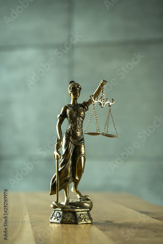 Law and Justice concept. Mallet of the judge  books  scales of justice. Gray stone background  reflections on the floor  place for typography. Courtroom theme.