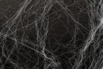 Artificial cobweb or spaider web on a black background. Abstract background. Top view, concept Happy halloween