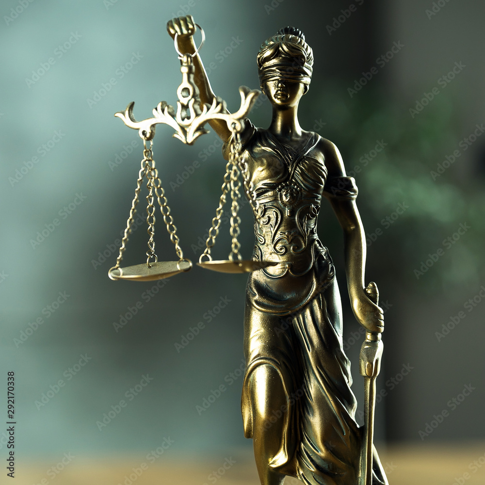 Fototapeta premium Law and Justice concept. Mallet of the judge, books, scales of justice. Gray stone background, reflections on the floor, place for typography. Courtroom theme.