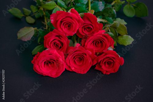 Romantic bouquet of red roses on the table. Event design style. Romantic atmospheric photo of flowers
