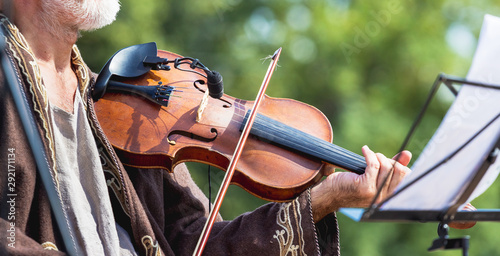 Musician with violin outdoors during concert, panorama_