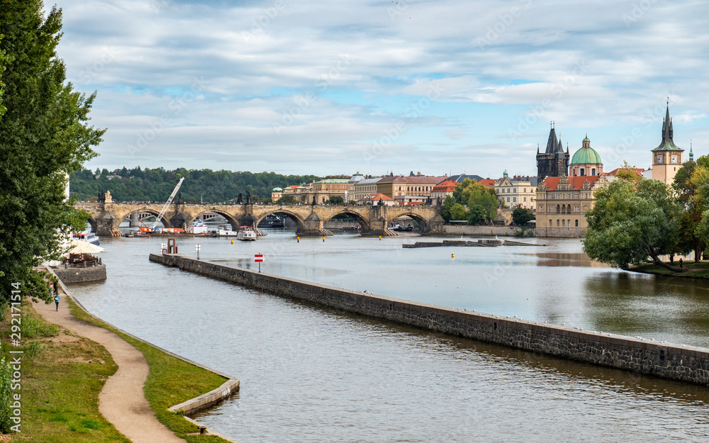 The Vlatava River, Prague, Czech Republic, with the landmark Charles Bridge and Old Town Bridge Tower in the distance.