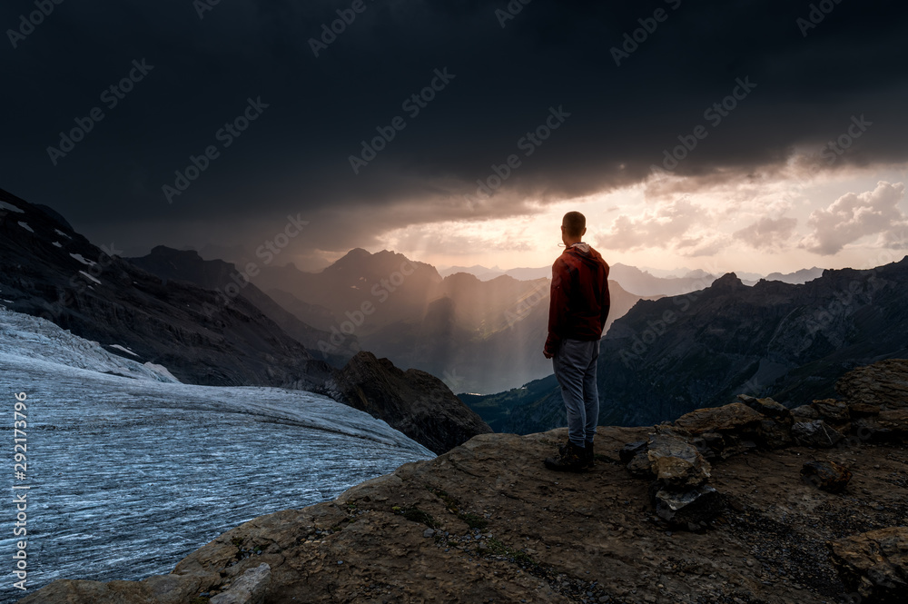 silhouette of a man standing in front of Blümlisalpgletscher at Blümlisalphütte SAC silhouette of a man standing in front of Blümlisalpgletscher at Blümlisalphütte SAC