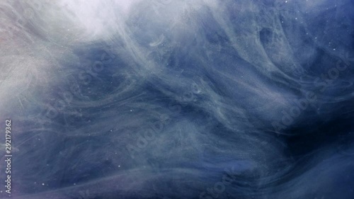 Smoke flow. Magic spell. White glitter haze cloud motion over blue background. photo