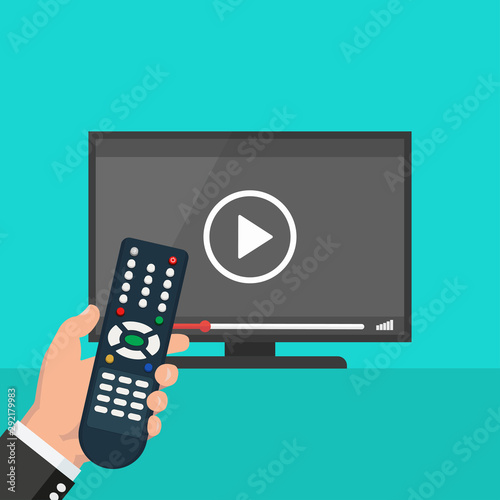 Hand holding wireless remote control near flat screen tv watching video film, cartoon person watching movie on television display