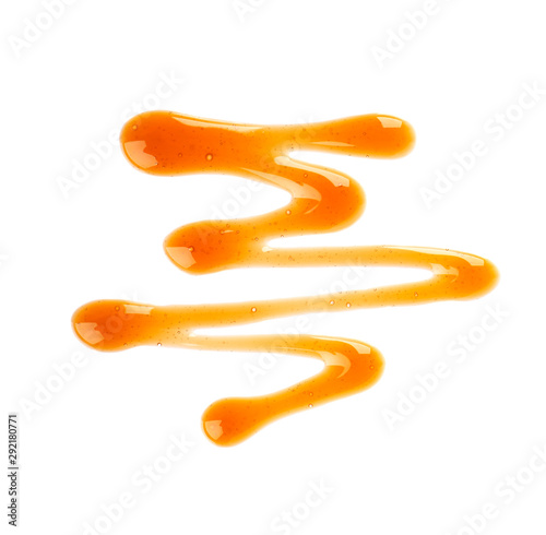 Caramel syrup drizzle isolated on white background. Splashes of sweet caramel sauce. Top view. photo