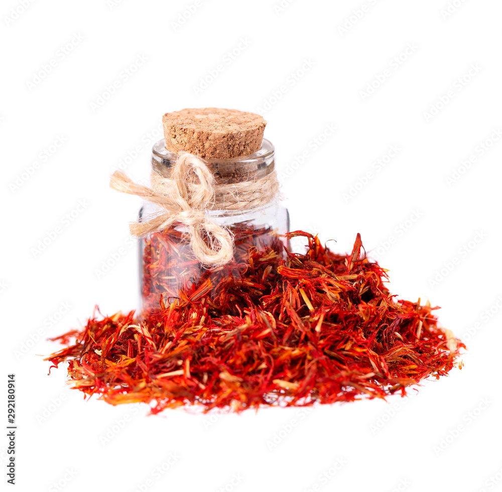 Fototapeta premium Pile of Saffron in glass jar, isolated on white background. Dried saffron spice.