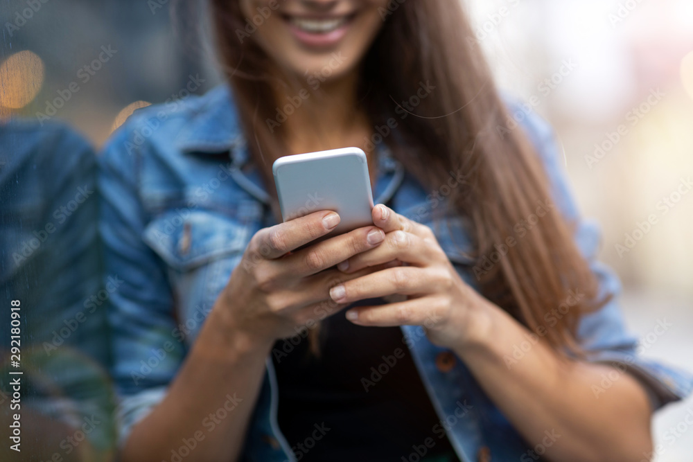 Young woman with smartphone in an urban city area Young woman with smartphone in an urban city area