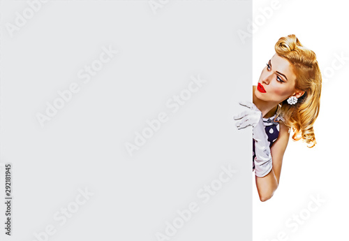 Portrait of beautiful blond girl in pin up style, showing blank signboard with copy space area for some text, slogan or advertising, isolated over white photo