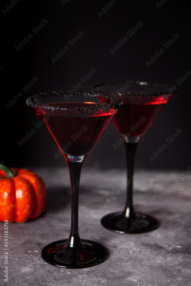 Two glasses with red cocktail for Halloween party on the dark background Two glasses with red cocktail for Halloween party on the dark background