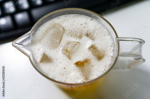 Bubbling beer in a glass with cool ice
