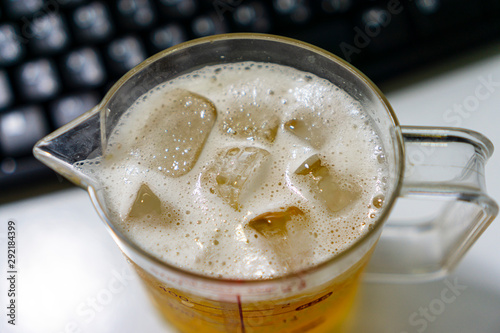 Bubbling beer in a glass with cool ice