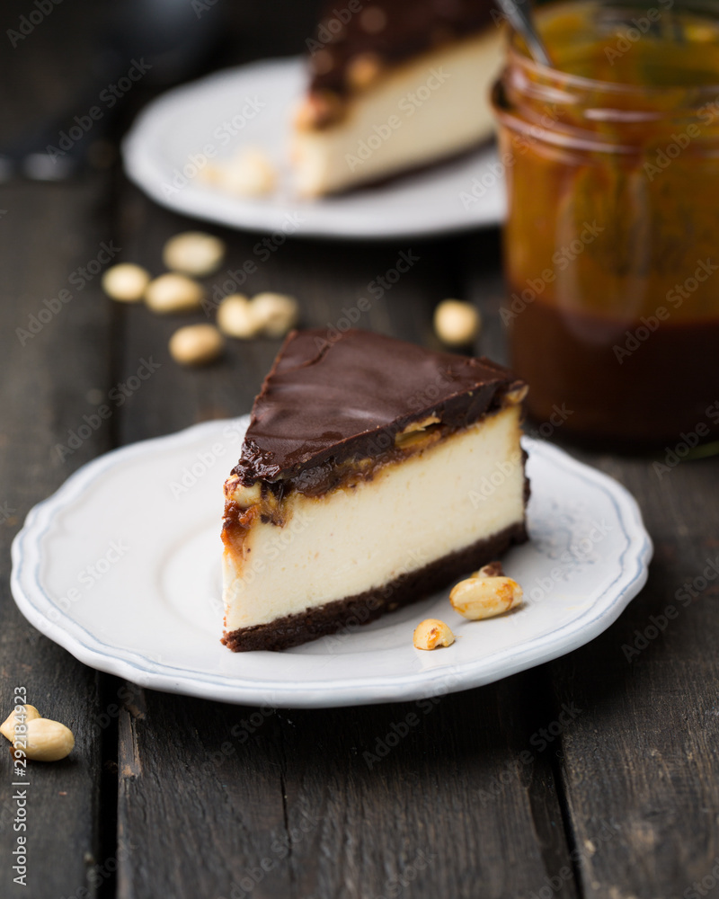 A classic creamy cheesecake with a chocolate base, roasted peanuts, salted caramel and chocolate - a favorite popular chocolate sweet A classic creamy cheesecake with a chocolate base, roasted peanuts, salted caramel and chocolate - a favorite popular chocolate sweet