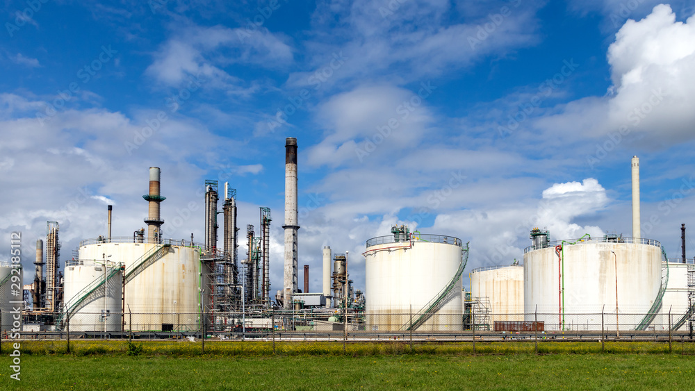 Industrial pipelines and silos at an oil refinery plant. Industrial pipelines and silos at an oil refinery plant.